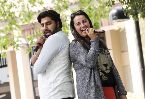 Govav Bagga, 20, and Liz Quinteno, 19, sing back to back during De Anza's Club Karaoke day in the main quad, Thursday, April 17.