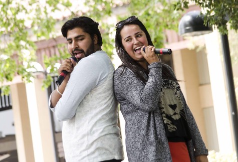 Govav Bagga, 20,  and Liz Quinteno, 19,  sing back to back during De Anza's Club Karaoke day in the main quad, Thursday, April 17.