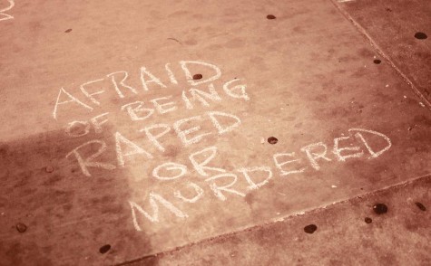 Students use chalk in an activity to express their fears of being alone in the Flint Center parking garage.